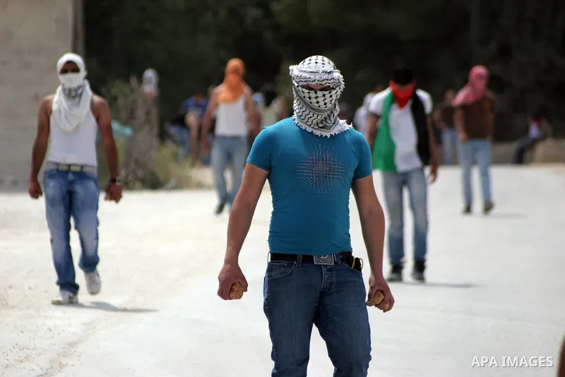 Masked Palestinian demonstrators hurl stones toward Israeli soldiers during a demonstration in the West Bank village of Al-khader near Bethlehem, Friday, May 20, 2011. President Barack Obama on Thursday finally uttered t...