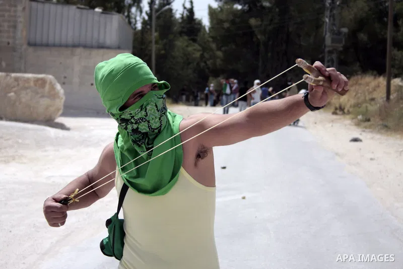 Masked Palestinian demonstrators hurl stones toward Israeli soldiers during a demonstration in the West Bank village of Al-khader near Bethlehem, Friday, May 20, 2011. President Barack Obama on Thursday finally uttered t...