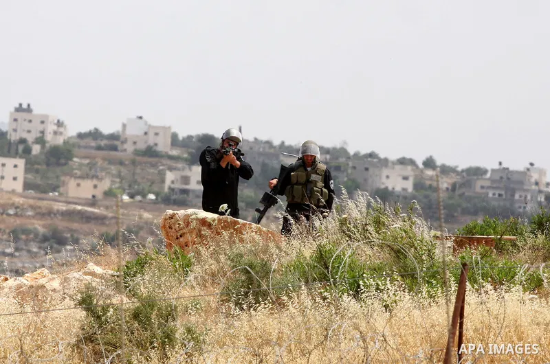Israeli soldiers stand guard during clashes with Palestinian youths following the weekly demonstration against Israel's separation barrier in the West Bank village of Bilin, near Ramallah, Friday, May 20, 2011. President...