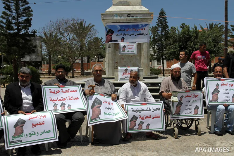 Palestinian protesters hold banners during an effectiveness to prevent them from obtaining passports by Ramallah, in Gaza city on May 21, 2011. Palestinians condemn it , and raise slogans against the political partisansh...