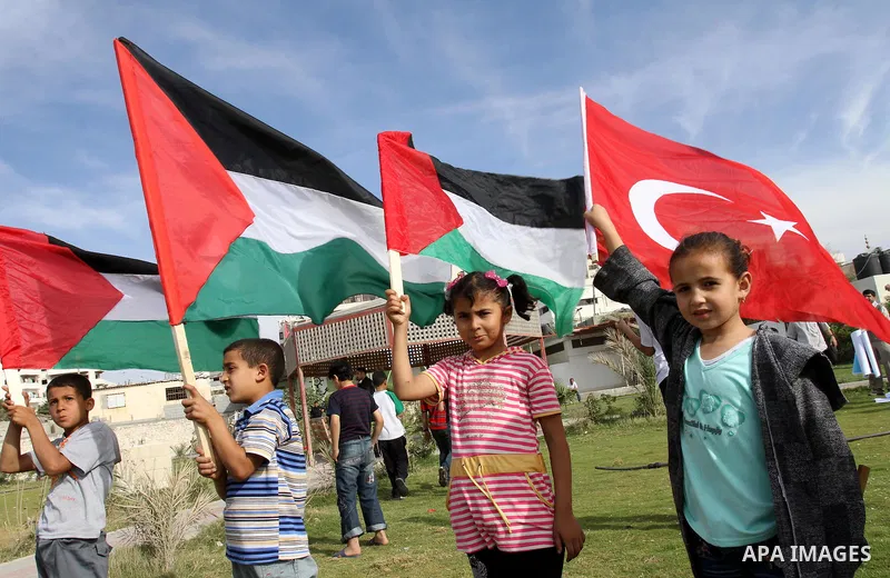 Palestinian children wave their national flag and Turkish flag during a protest in the 2nd anniversary of the killing of Turkish activists who killed by Israeli navy, in Gaza City on May 21,2011. Photo by Mohammed Asad