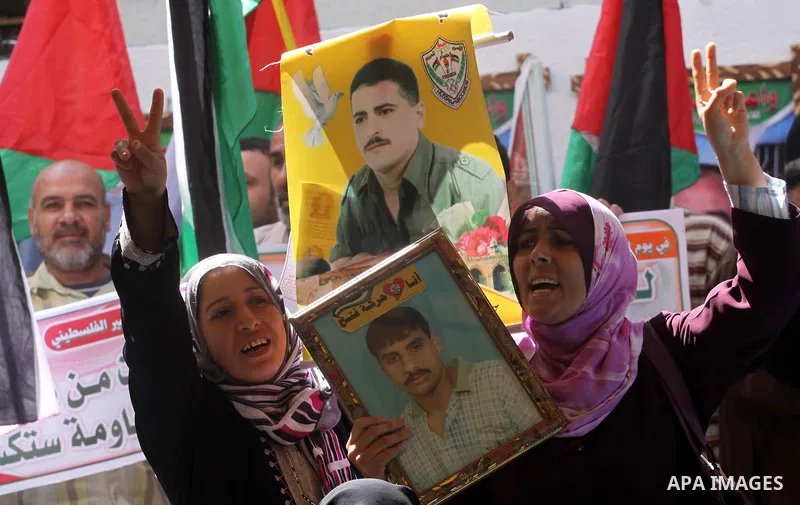 Palestinians women hold pictures of their jailed relatives during a rally, at the headquarters of the Red cross calling for the release of Palestinian prisoners from Israeli jails, in Gaza city on May 23, 2011. Photo by...