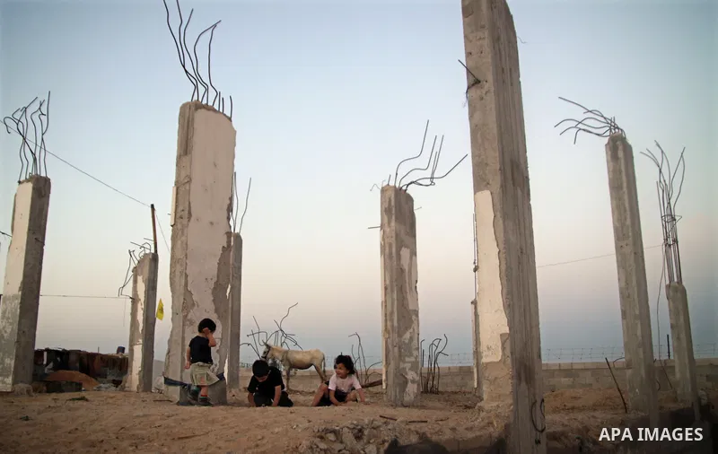 Palestinian children play outside a tent which was erected outside their family house in Jabaliya refugee camp, in the northern Gaza Strip, 24 May 2011. Their house was destroyed during the Israeli assault on Gaza in lat...