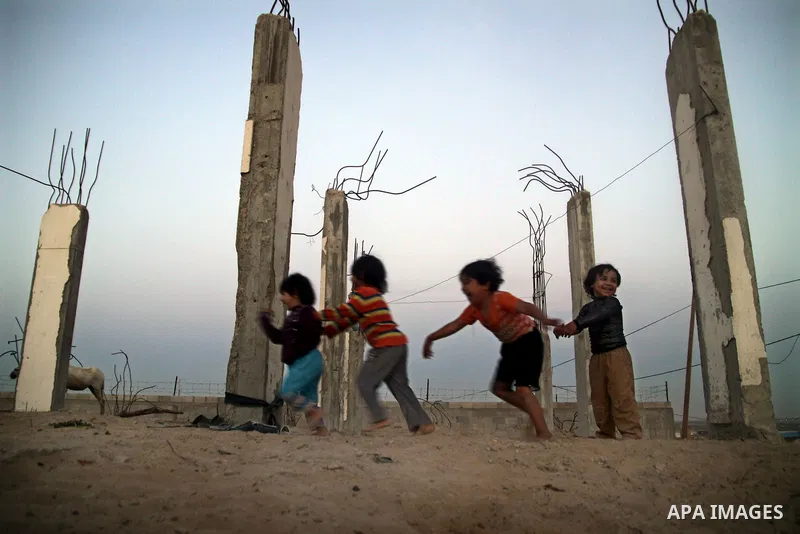 Palestinian children play outside a tent which was erected outside their family house in Jabaliya refugee camp, in the northern Gaza Strip, 24 May 2011. Their house was destroyed during the Israeli assault on Gaza in lat...