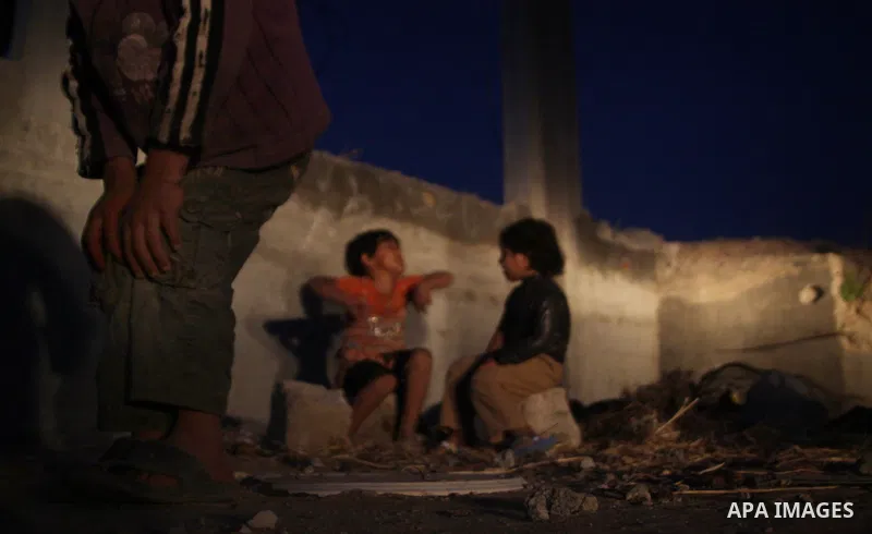 Palestinian children play outside a tent which was erected outside their family house in Jabaliya refugee camp, in the northern Gaza Strip, 24 May 2011. Their house was destroyed during the Israeli assault on Gaza in lat...