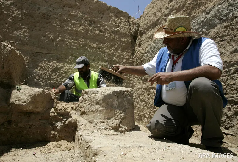 Palestinian workers excavate for ancient artifacts recently discovered near the Egyptian border town of Rafah are displayed by the Hamas-run ministry of tourism and antiquities in the southern Gaza Strip on May 25, 2011....