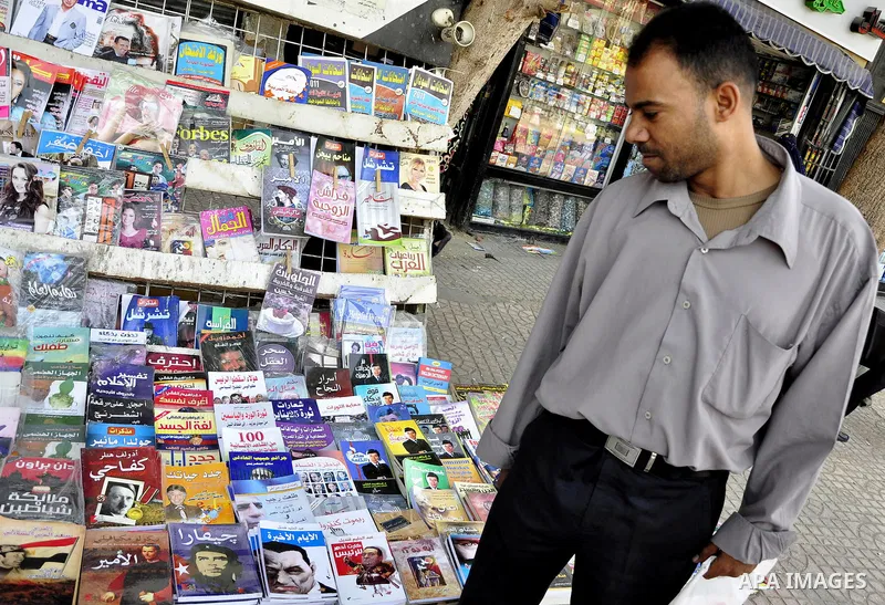 An Egyptian man looks at books and magazines with a front page picture of ousted Egyptian leader Hosni Mubarak on May 25, 2011, a day after the State prosecutor announced that Mubarak and his two sons would face trial in...