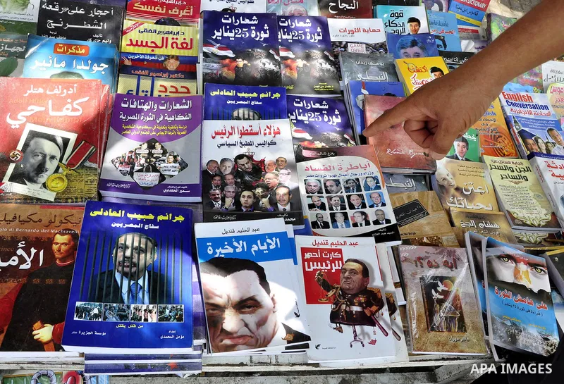 An Egyptian man looks at books and magazines with a front page picture of ousted Egyptian leader Hosni Mubarak on May 25, 2011, a day after the State prosecutor announced that Mubarak and his two sons would face trial in...