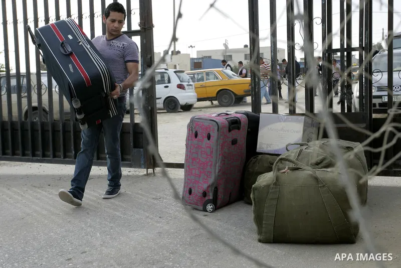 Palestinians wait to cross into Egypt through the Rafah border terminal in the southern Gaza Strip on May 26, 2011, a day after the official MENA news agency reported that Egypt will open the crossing on a daily basis st...
