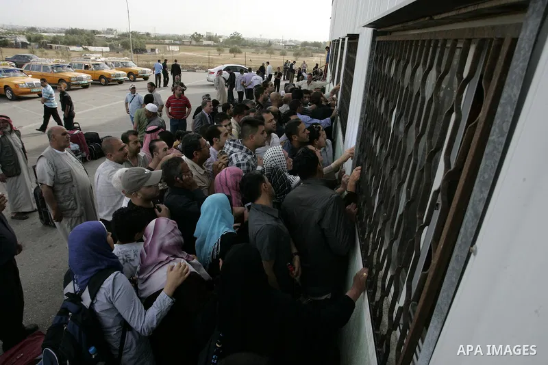 Palestinians wait to cross into Egypt through the Rafah border terminal in the southern Gaza Strip on May 26, 2011, a day after the official MENA news agency reported that Egypt will open the crossing on a daily basis st...