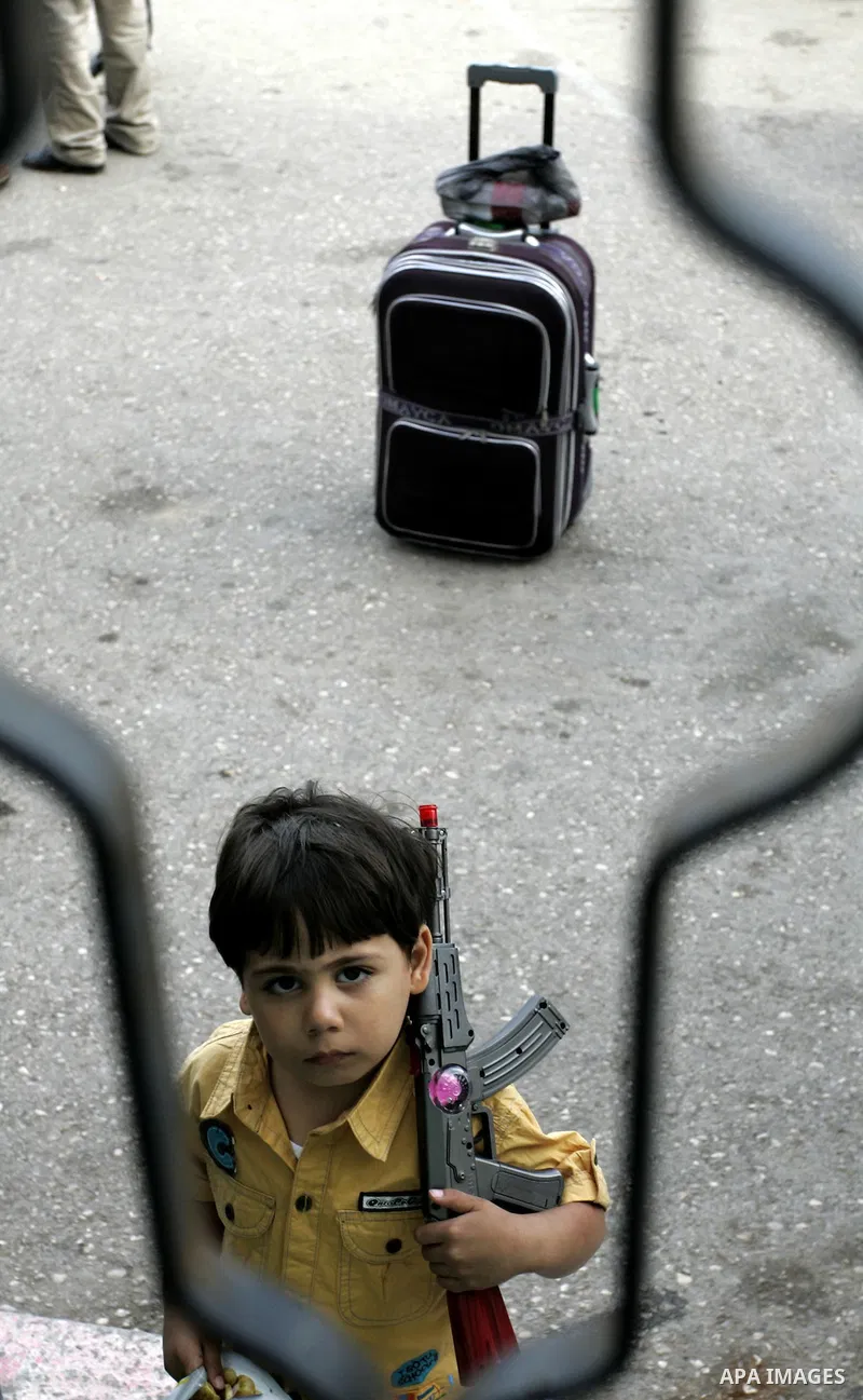 Palestinian boy waits to cross into Egypt through the Rafah border terminal in the southern Gaza Strip on May 26, 2011, a day after the official MENA news agency reported that Egypt will open the crossing on a daily basi...