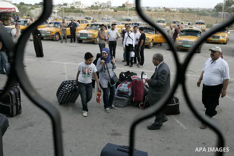 Palestinians wait to cross into Egypt through the Rafah border terminal in the southern Gaza Strip on May 26, 2011, a day after the official MENA news agency reported that Egypt will open the crossing on a daily basis st...