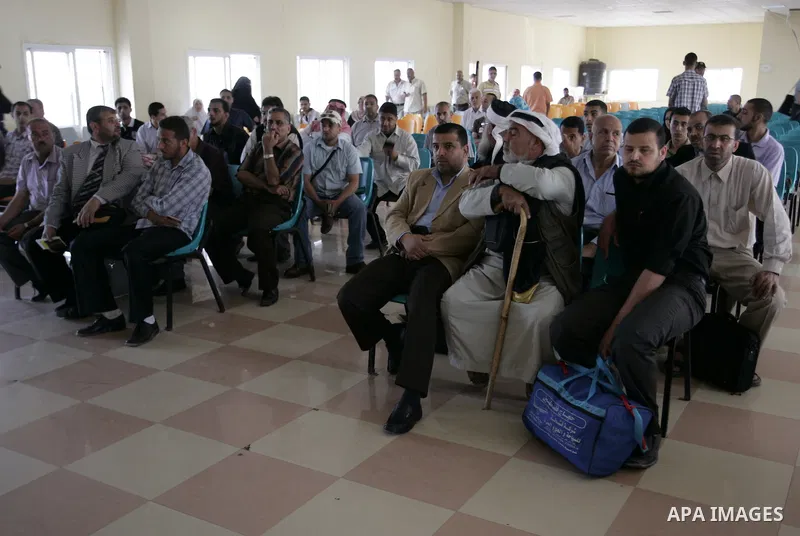 Palestinians wait to cross into Egypt through the Rafah border terminal in the southern Gaza Strip on May 26, 2011, a day after the official MENA news agency reported that Egypt will open the crossing on a daily basis st...
