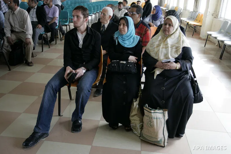 Palestinians wait to cross into Egypt through the Rafah border terminal in the southern Gaza Strip on May 26, 2011, a day after the official MENA news agency reported that Egypt will open the crossing on a daily basis st...