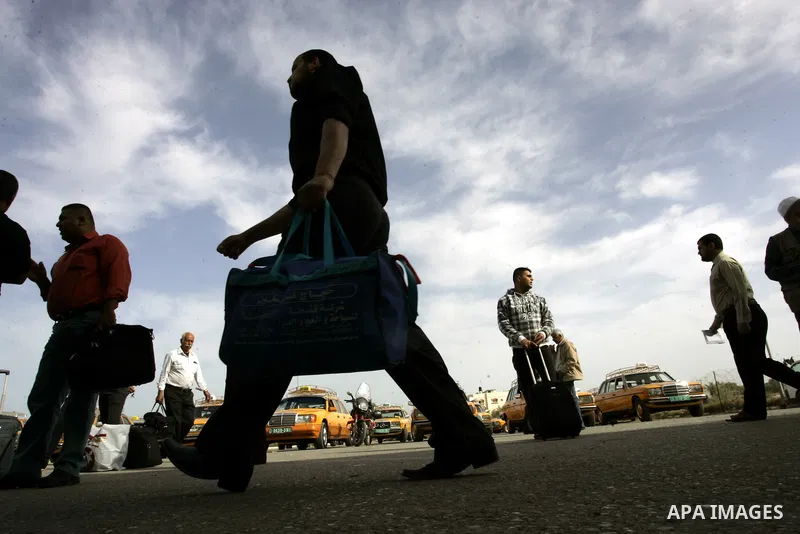 Palestinians wait to cross into Egypt through the Rafah border terminal in the southern Gaza Strip on May 26, 2011, a day after the official MENA news agency reported that Egypt will open the crossing on a daily basis st...