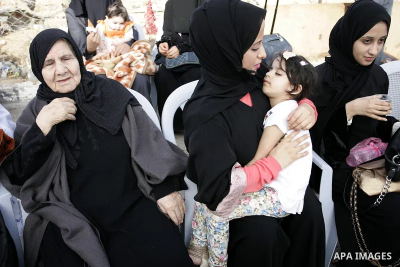 Palestinian women wait to cross into Egypt through the Rafah border terminal in the southern Gaza Strip on May 26, 2011, a day after the official MENA news agency reported that Egypt will open the crossing on a daily bas...