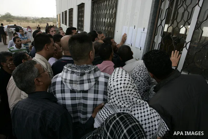 Palestinians wait to cross into Egypt through the Rafah border terminal in the southern Gaza Strip on May 26, 2011, a day after the official MENA news agency reported that Egypt will open the crossing on a daily basis st...