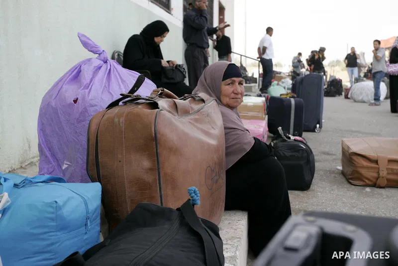 Palestinian women wait to cross into Egypt through the Rafah border terminal in the southern Gaza Strip on May 26, 2011, a day after the official MENA news agency reported that Egypt will open the crossing on a daily bas...