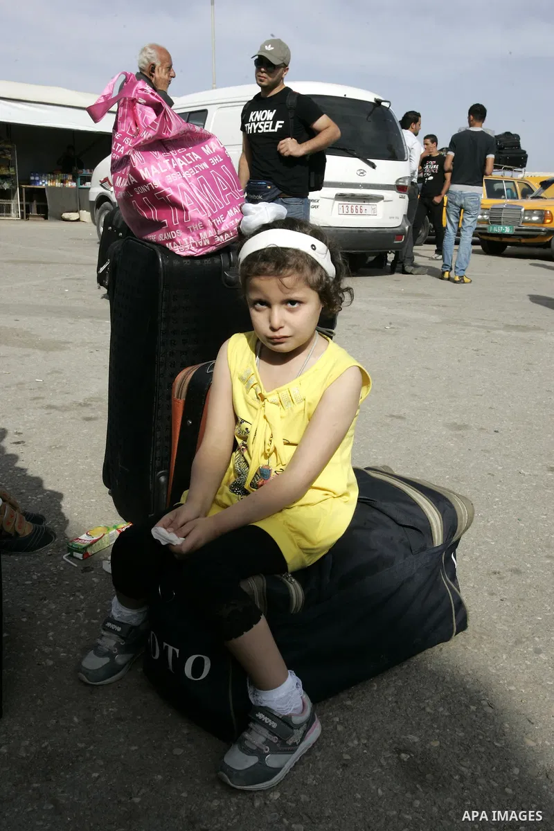 Palestinian girl waits to cross into Egypt through the Rafah border terminal in the southern Gaza Strip on May 26, 2011, a day after the official MENA news agency reported that Egypt will open the crossing on a daily bas...