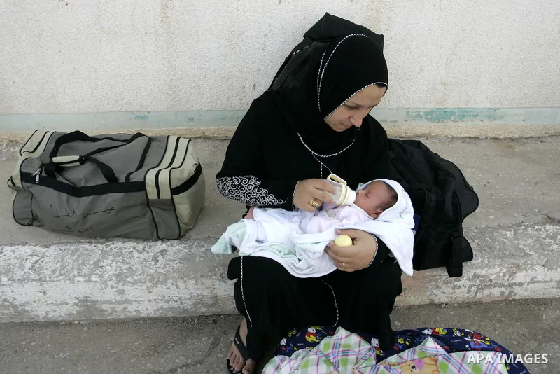 Palestinian woman waits to cross into Egypt through the Rafah border terminal in the southern Gaza Strip on May 26, 2011, a day after the official MENA news agency reported that Egypt will open the crossing on a daily ba...