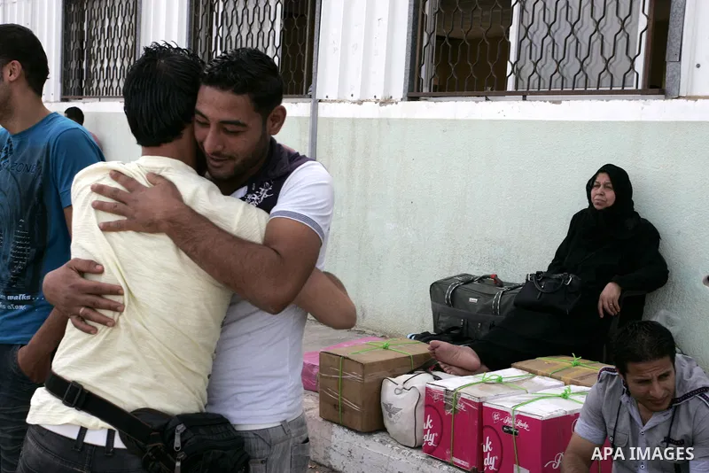 Palestinians wait to cross into Egypt through the Rafah border terminal in the southern Gaza Strip on May 26, 2011, a day after the official MENA news agency reported that Egypt will open the crossing on a daily basis st...