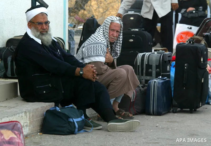 Palestinians wait to cross into Egypt through the Rafah border terminal in the southern Gaza Strip on May 26, 2011, a day after the official MENA news agency reported that Egypt will open the crossing on a daily basis st...
