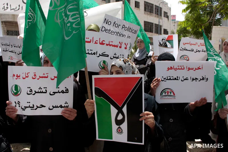 Hamas members of the Palestinian Legislative Council (PLC) take part with Palestinian supporters of the Hamas Islamist movement during a rally calling for the release of Palestinians being held in West Bank and Gaza Stri...
