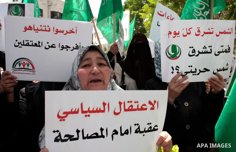 Hamas members of the Palestinian Legislative Council (PLC) take part with Palestinian supporters of the Hamas Islamist movement during a rally calling for the release of Palestinians being held in West Bank and Gaza Stri...