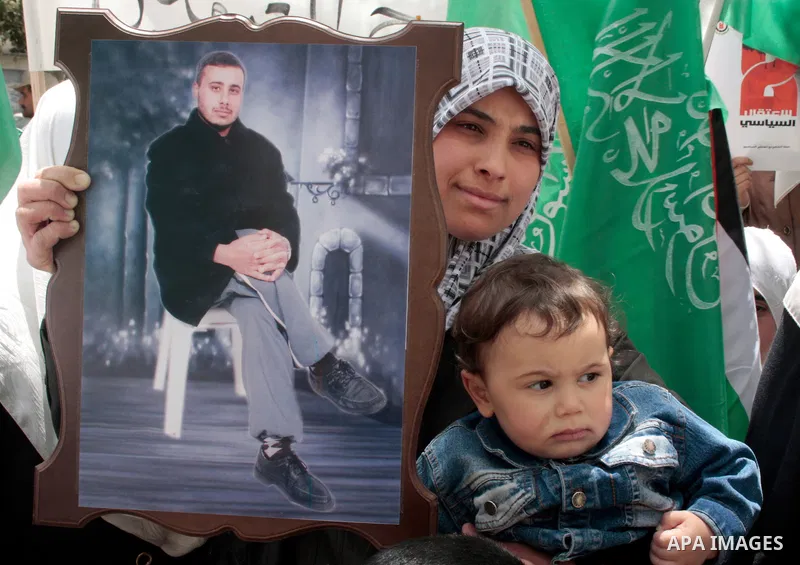 Hamas members of the Palestinian Legislative Council (PLC) take part with Palestinian supporters of the Hamas Islamist movement during a rally calling for the release of Palestinians being held in West Bank and Gaza Stri...