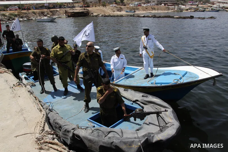 Hamas marine security take to the open waters during a drill in preparation for the arrival of ships expected to break the Israeli naval blockade on the port in Gaza City on the coast of the Mediterranean Sea on May 26,...