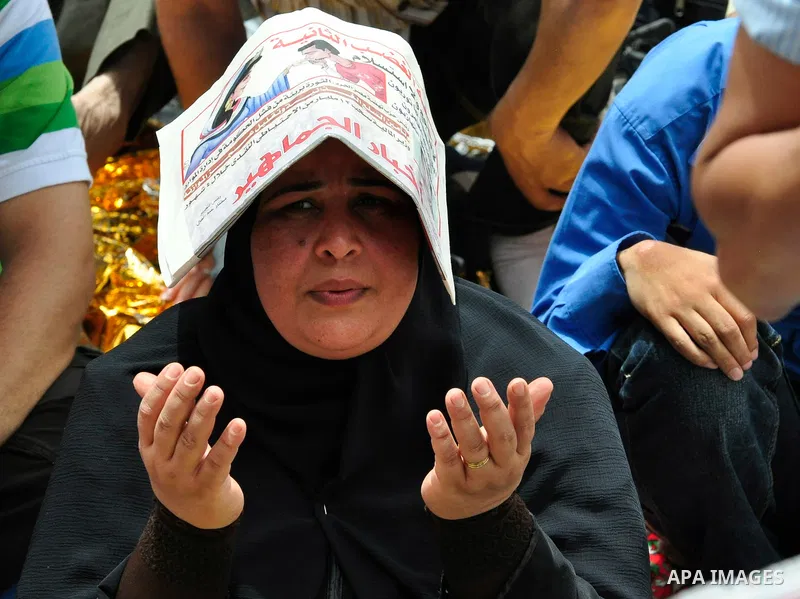 An Egyptian protester attends the weekly Muslim Friday prayers at Tahrir Square in Cairo, Egypt Friday, May 27, 2011. Thousands of protesters poured into downtown Cairo's Tahrir Square Friday for what they called a 'seco...