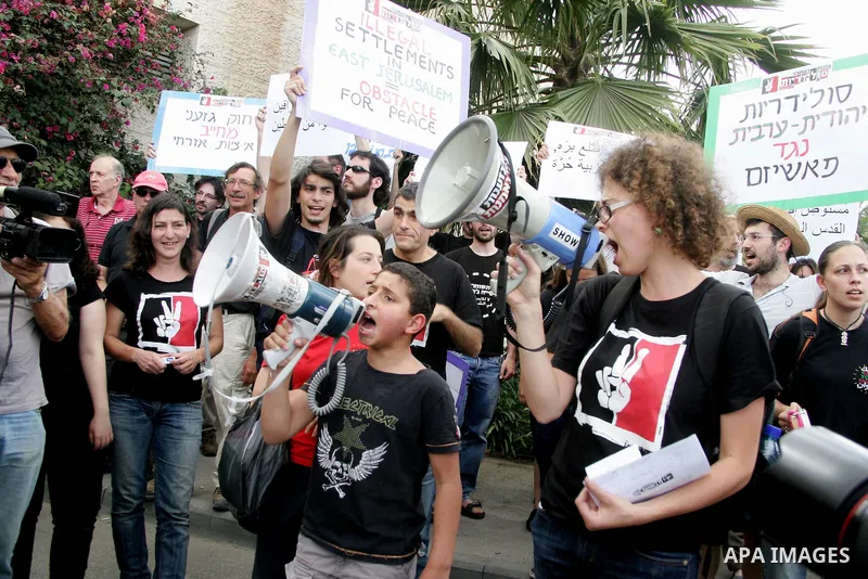 Left wing Israelis, Palestinians and international activists protest before the dedication ceremony for the Jewish neighborhood of Maale Hazeitim, inside the east Jerusalem area of Ras el Amud, Friday, May 27, 2011. Duri...