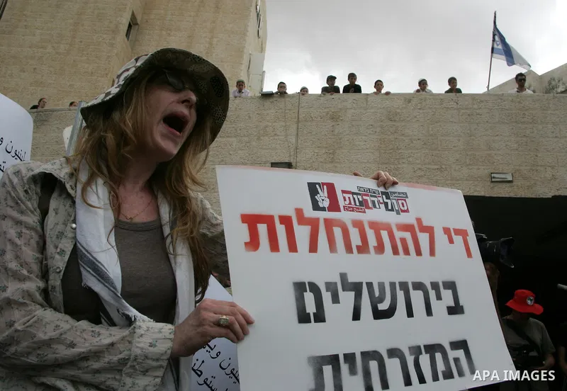 Left wing Israelis, Palestinians and international activists protest before the dedication ceremony for the Jewish neighborhood of Maale Hazeitim, inside the east Jerusalem area of Ras el Amud, Friday, May 27, 2011. Duri...