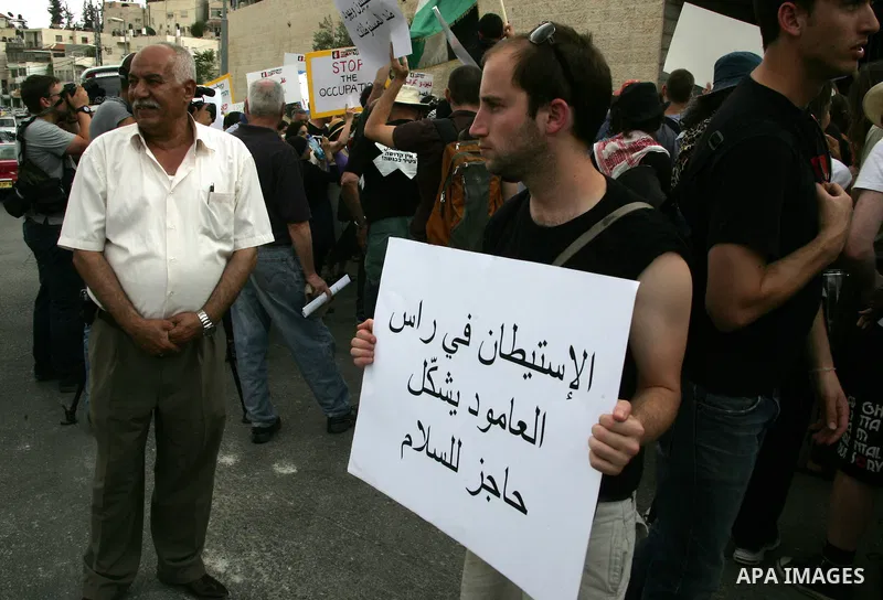 Left wing Israelis, Palestinians and international activists protest before the dedication ceremony for the Jewish neighborhood of Maale Hazeitim, inside the east Jerusalem area of Ras el Amud, Friday, May 27, 2011. Duri...