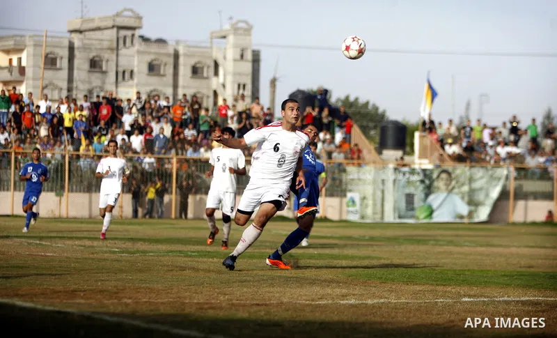 Palestinian Shabab Rafah player vies with Al-Shatea soccer club player during Gaza Strip league, in the southern Gaza Strip town Rafah on May 27,2011. The match ended 0-0.. Photo by Ali Jadallah