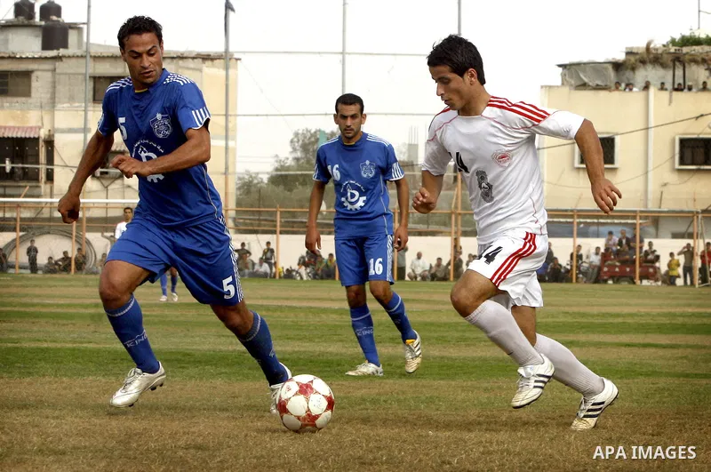 Palestinian Shabab Rafah player vies with Al-Shatea soccer club player during Gaza Strip league, in the southern Gaza Strip town Rafah on May 27,2011. The match ended 0-0.. Photo by Ali Jadallah