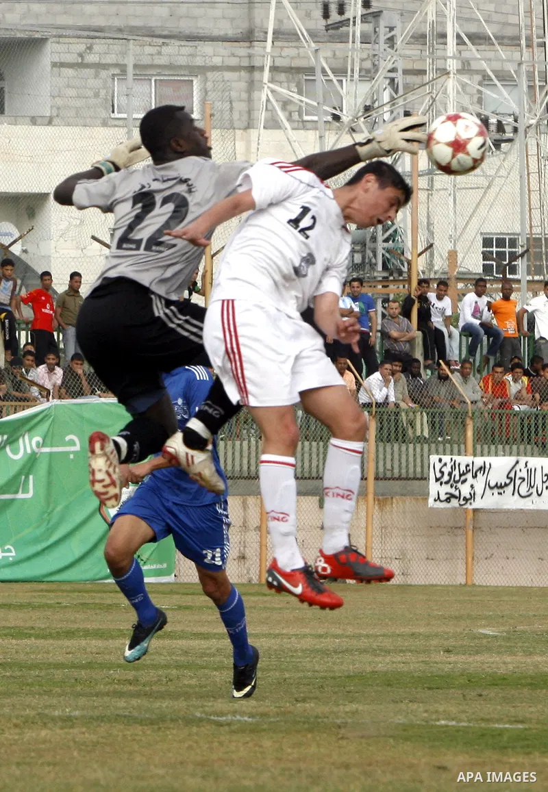 Palestinian Shabab Rafah player vies with Al-Shatea soccer club player during Gaza Strip league, in the southern Gaza Strip town Rafah on May 27,2011. The match ended 0-0.. Photo by Ali Jadallah