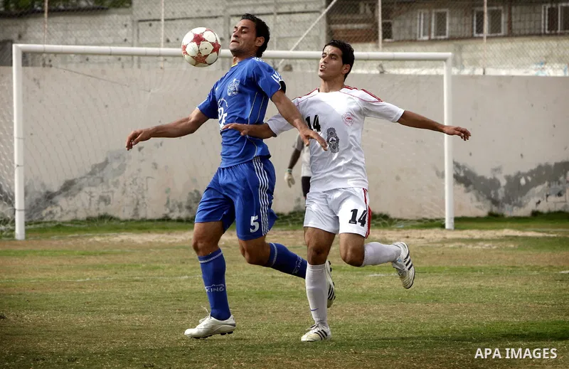 Palestinian Shabab Rafah player vies with Al-Shatea soccer club player during Gaza Strip league, in the southern Gaza Strip town Rafah on May 27,2011. The match ended 0-0.. Photo by Ali Jadallah