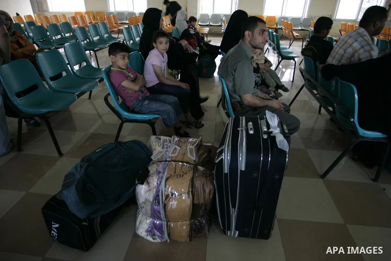 Palestinians wait to cross into Egypt through the Rafah border crossing in the southern Gaza Strip on May 28, 2011 as Egypt reopened the border, allowing people to cross freely for the first time in four years. Photo by...