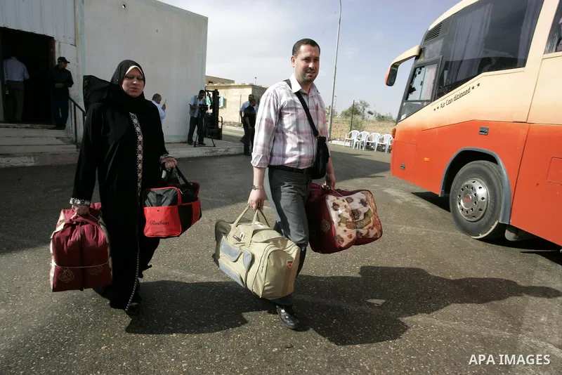 Palestinians load their luggage and wait to cross into Egypt through the Rafah border crossing in the southern Gaza Strip on May 28, 2011 as Egypt reopened the border, allowing people to cross freely for the first time i...