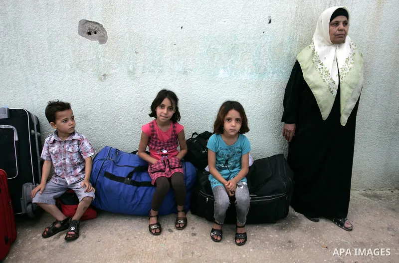 Palestinians wait to cross into Egypt through the Rafah border crossing in the southern Gaza Strip on May 28, 2011 as Egypt reopened the border, allowing people to cross freely for the first time in four years. Photo by...