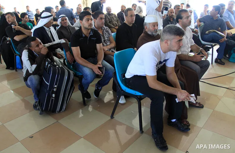 Palestinians wait to cross into Egypt through the Rafah border crossing in the southern Gaza Strip on May 28, 2011 as Egypt reopened the border, allowing people to cross freely for the first time in four years. Photo by...