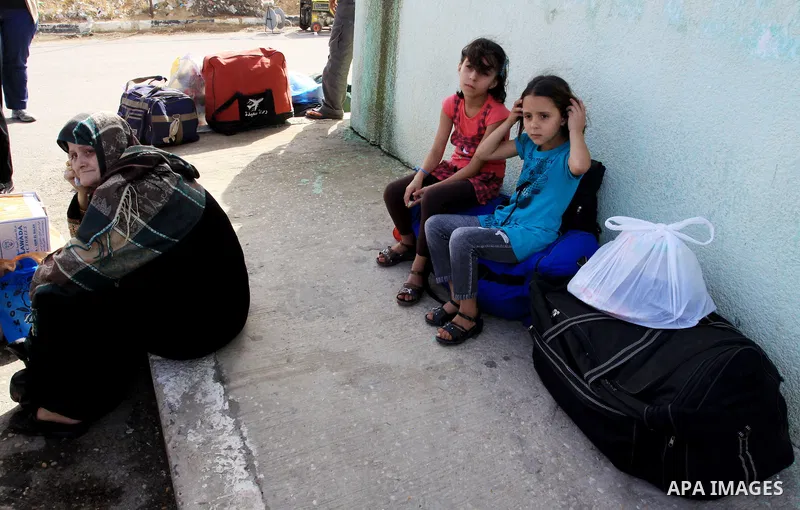 Palestinians wait to cross into Egypt through the Rafah border crossing in the southern Gaza Strip on May 28, 2011 as Egypt reopened the border, allowing people to cross freely for the first time in four years. Photo by...
