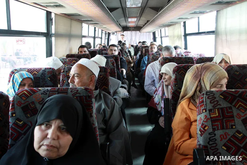 Palestinians sit in a bus as they wait to cross into Egypt through the Rafah border crossing in the southern Gaza Strip on May 28, 2011 as Egypt reopened the border, allowing people to cross freely for the first time in...