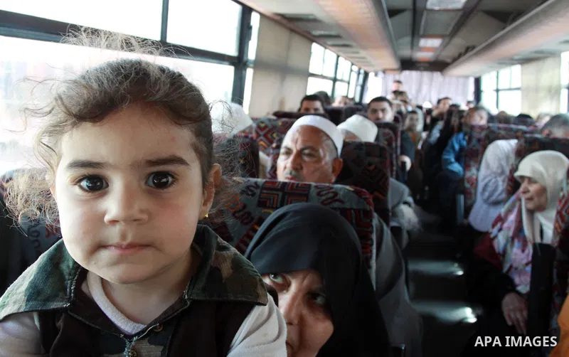 Palestinians sit in a bus as they wait to cross into Egypt through the Rafah border crossing in the southern Gaza Strip on May 28, 2011 as Egypt reopened the border, allowing people to cross freely for the first time in...