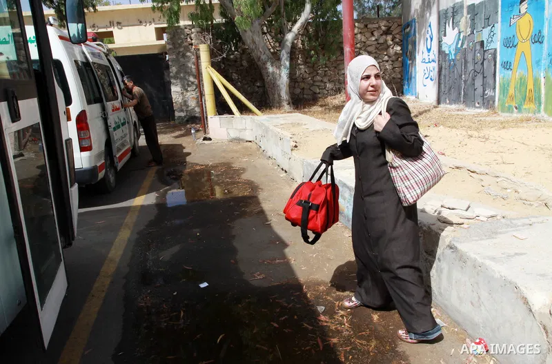 A Palestinian woman waits to cross into Egypt through the Rafah border crossing in the southern Gaza Strip on May 28, 2011 as Egypt reopened the border, allowing people to cross freely for the first time in four years. P...