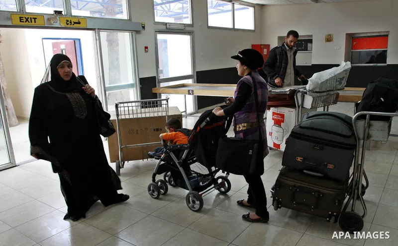 Palestinians returnees come through the Rafah border crossing in the southern Gaza Strip on May 28, 2011 as Egypt reopened the border, allowing people to cross freely for the first time in four years. Photo by Naaman Oma...