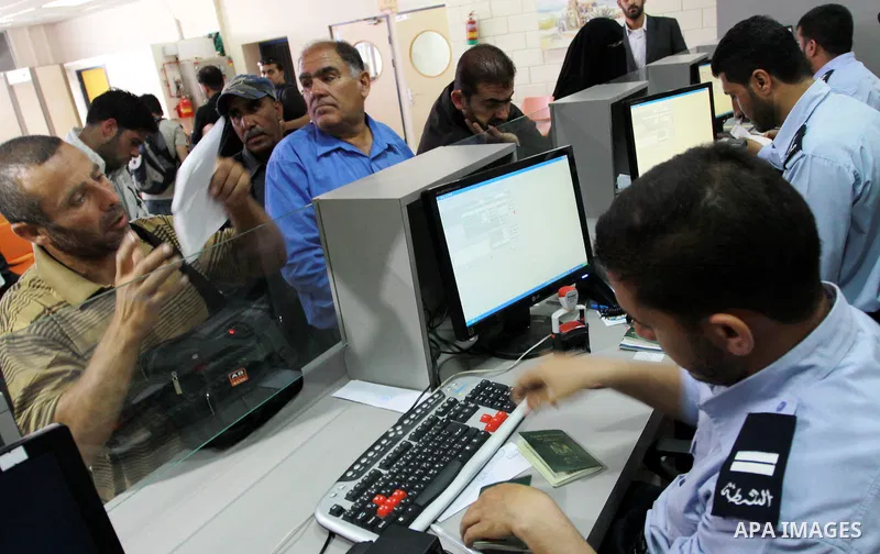 Palestinian border police check identity documents of travellers crossing into Egypt through the Rafah border crossing in the southern Gaza Strip on May 28, 2011 as Egypt reopened the border, allowing people to cross fre...