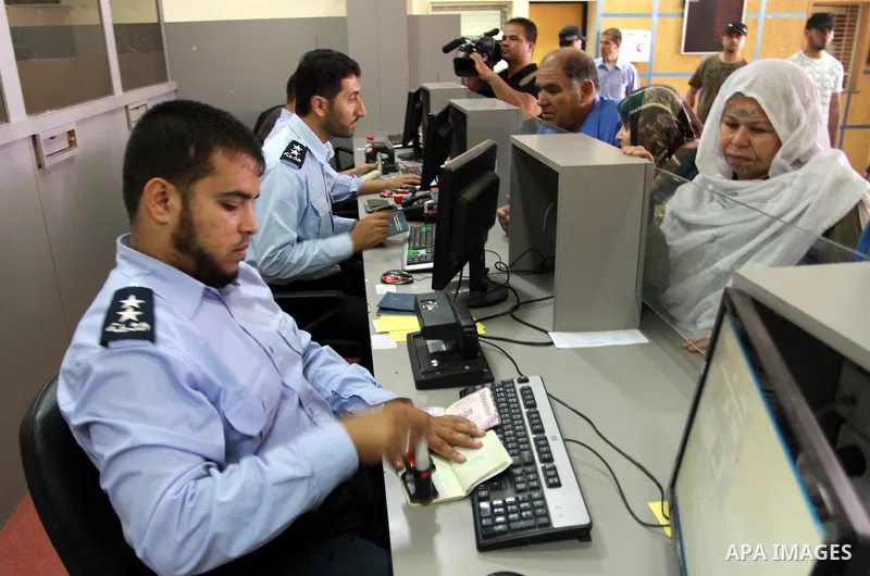 Palestinian border police check identity documents of travellers crossing into Egypt through the Rafah border crossing in the southern Gaza Strip on May 28, 2011 as Egypt reopened the border, allowing people to cross fre...