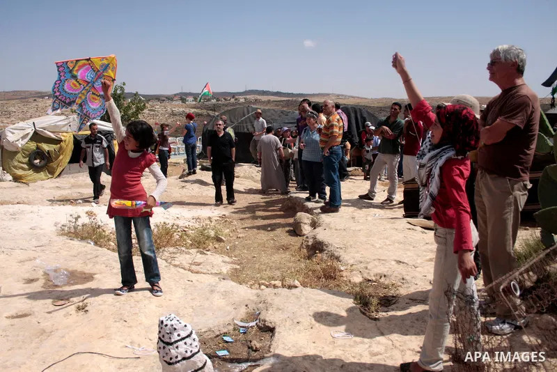 Palestinian, left-wing Israeli and foreign peace activists take part in the opening of the Susiya Creative and Learning Center in the mountains in the area of Yatta village close to the Jewish settlement of Sosia south o...